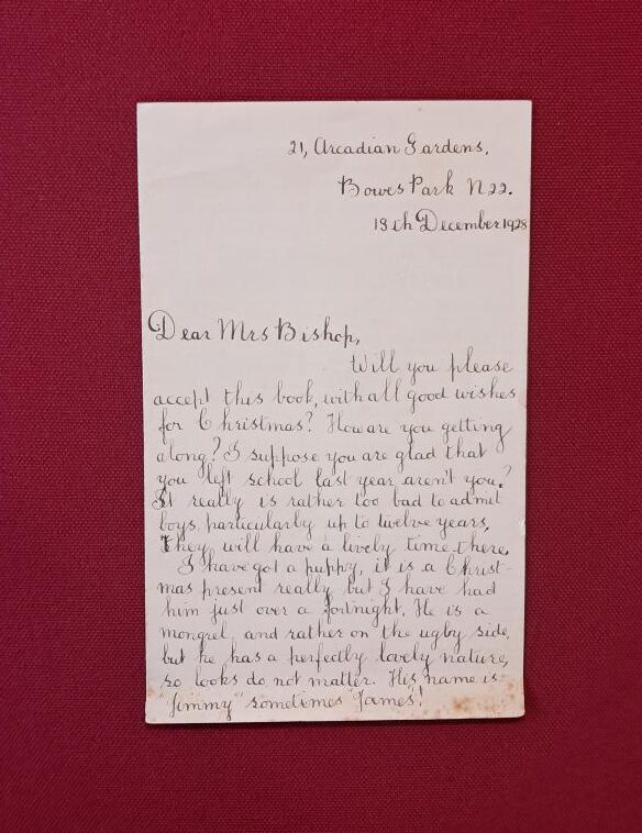 A cream letter lies flat on a red background